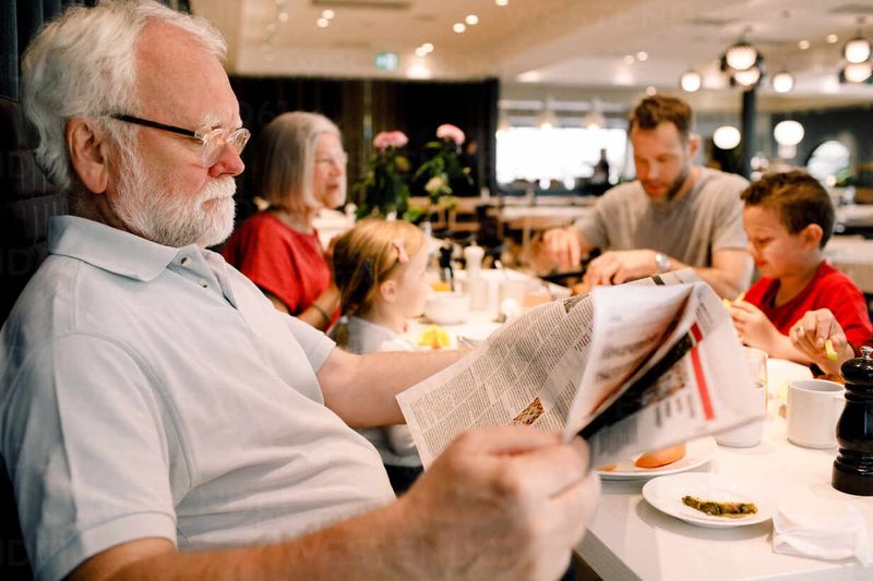 Reading the Newspaper Over Breakfast