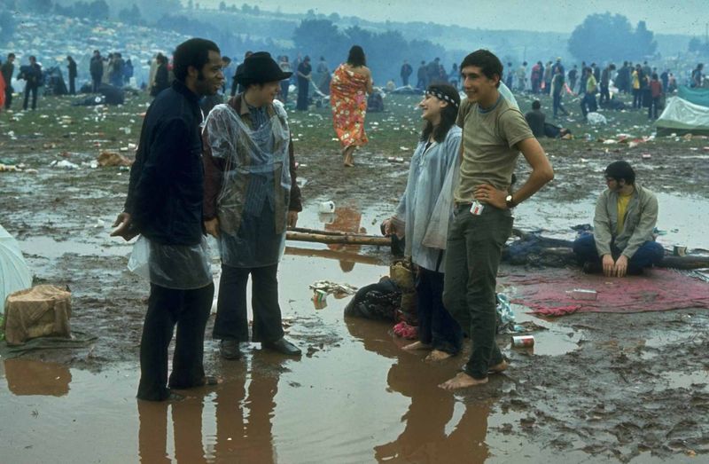 Mud-Sliding Festival-Goers – Happy attendees playing in the rain and mud