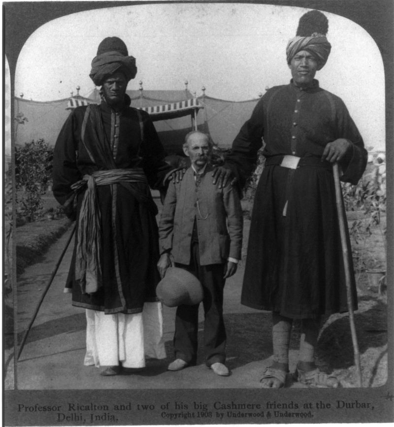 Two Kashmiri giants with photographer James Ricalton (1903)
