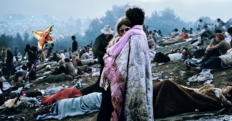 Couple Wrapped in a Blanket – A young pair huddled together in the crowd