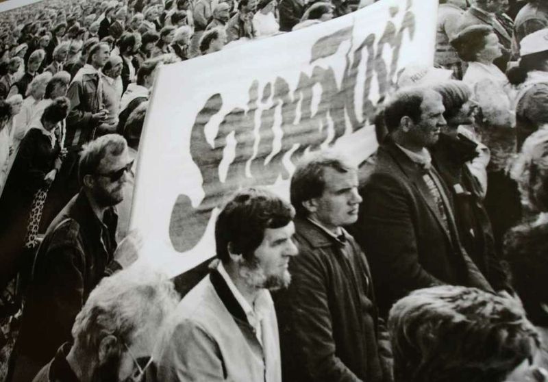 Father and son holding Solidarity slogans (Poland, 1980s)