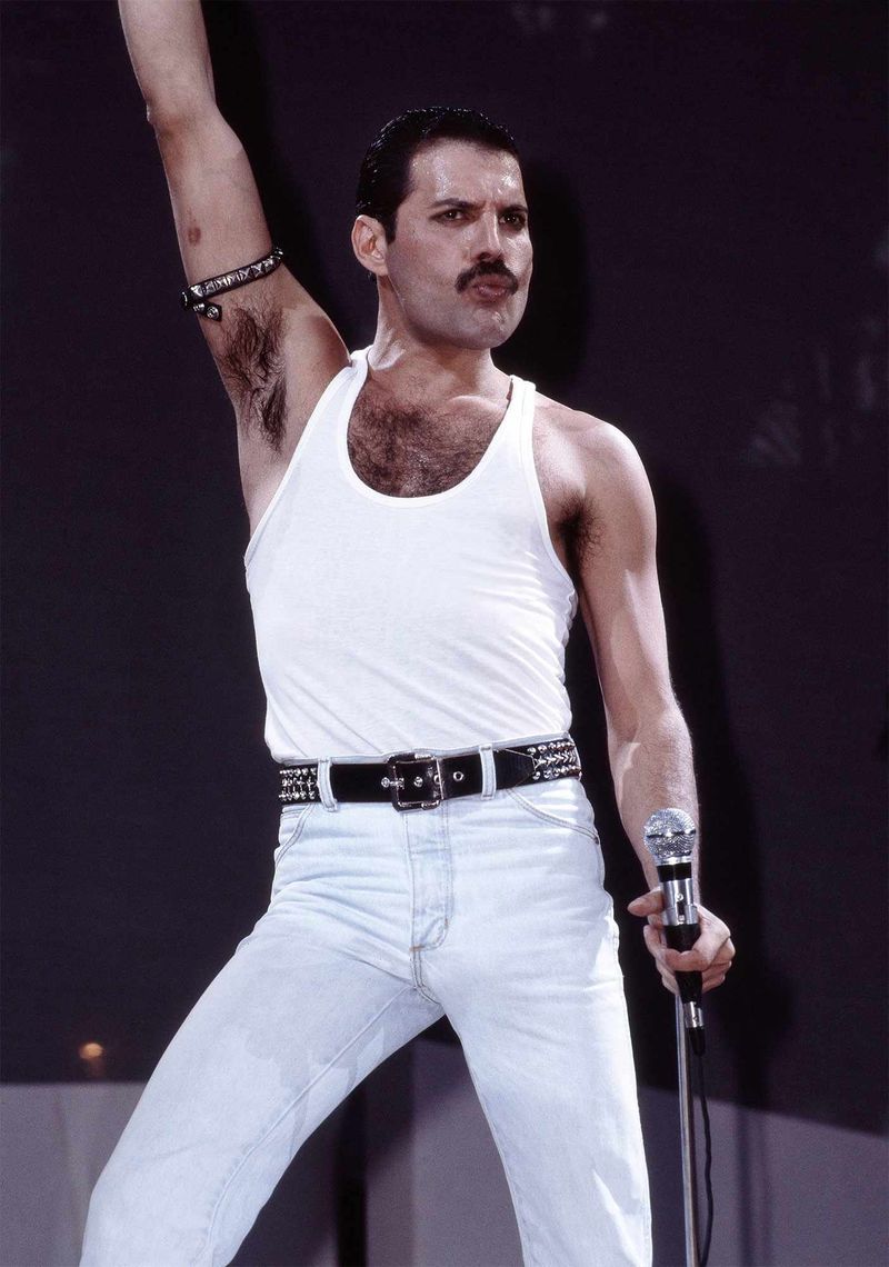 Freddie Mercury – Live Aid 1985, owning the stage in a tank top and jeans.