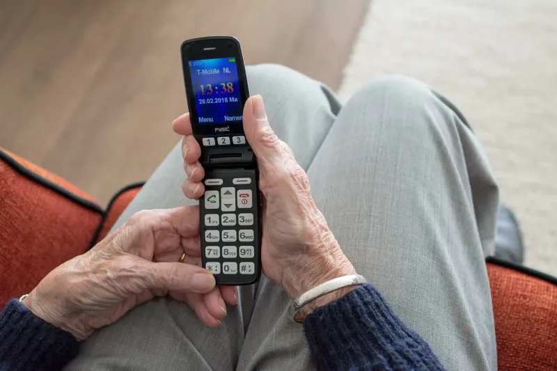 Pulling Out a Flip Phone to Show 47 Blurry Grandkid Photos