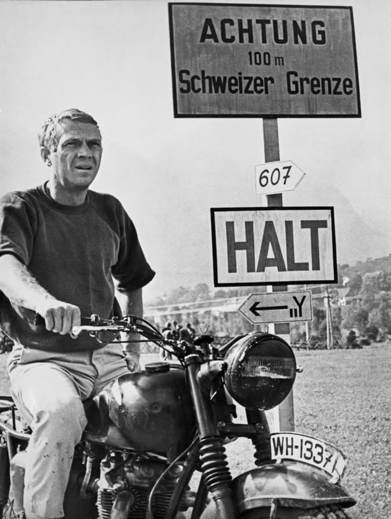 Steve McQueen – Coolly leaning on his motorcycle in The Great Escape (1963).