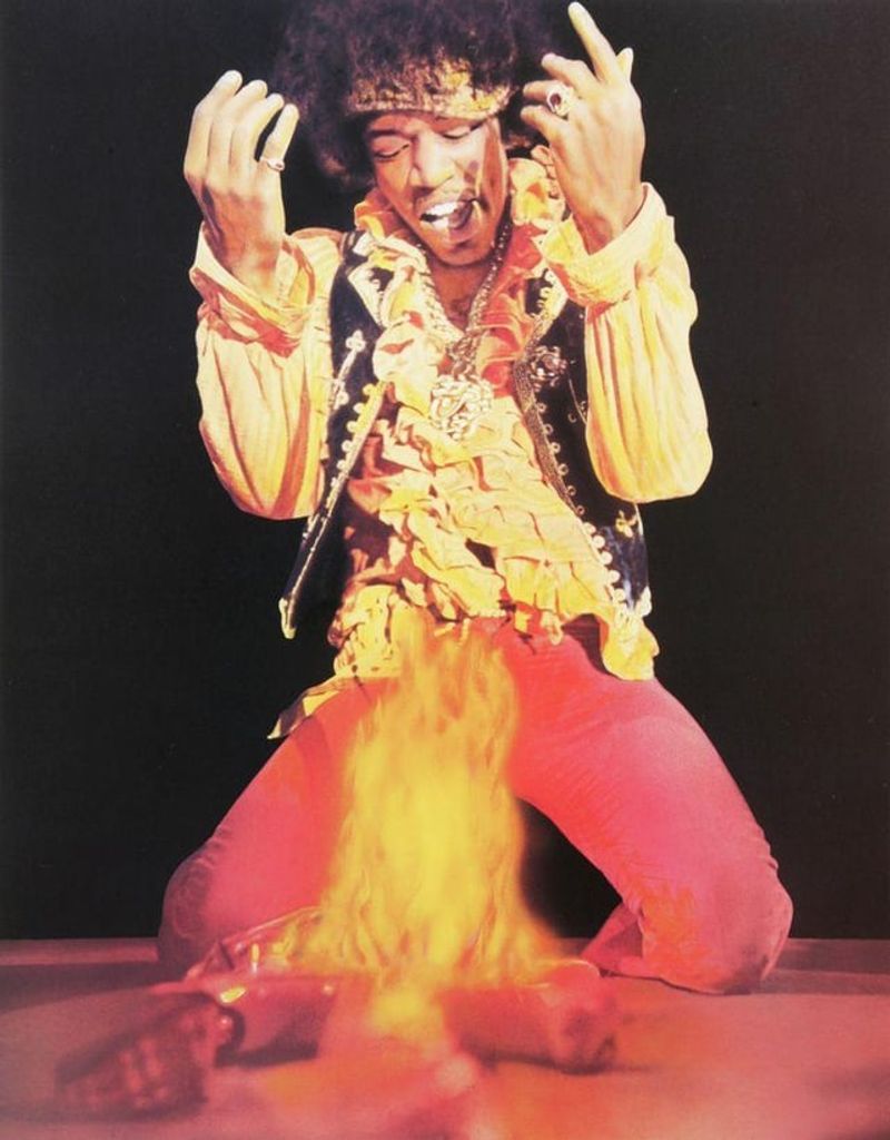 Jimi Hendrix – Burning his guitar at Monterey Pop Festival (1967).